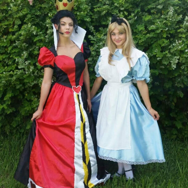 Two women dressed in colorful cosplay costumes standing outdoors.